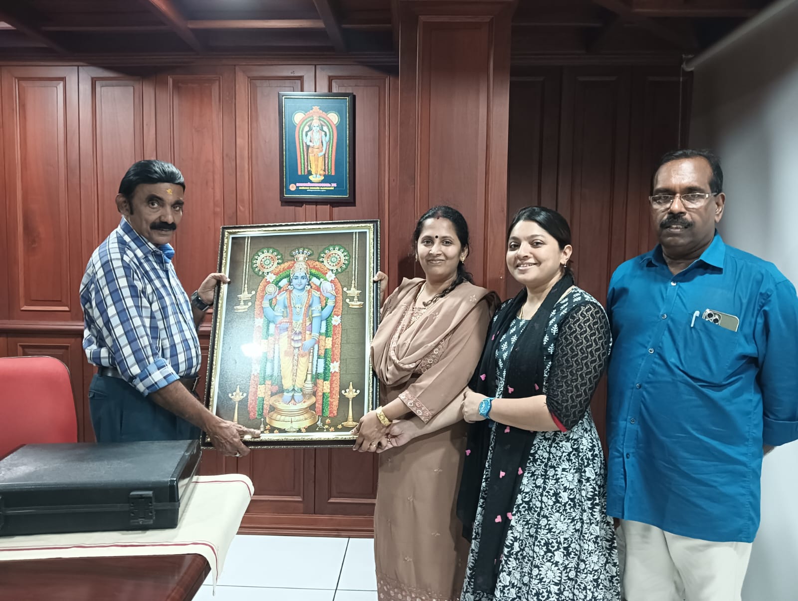 Aradhana Building MD, along with Aradhana Building Manager Sathyetan, handing over the Guruvayurappan's image for L P GIMSAT. 