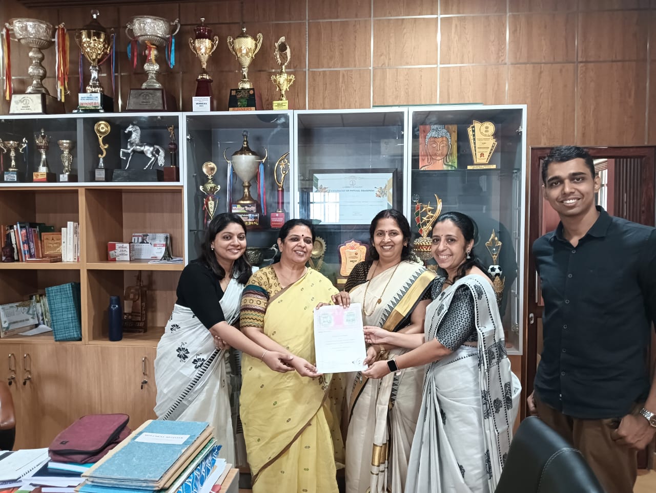 LP GIMSAT team With the Principal of ZGC, Dr. B Rajini. Holding the signed MoU for integration of add-on courses for students in LP GIMSAT's Diploma in Aviation program.